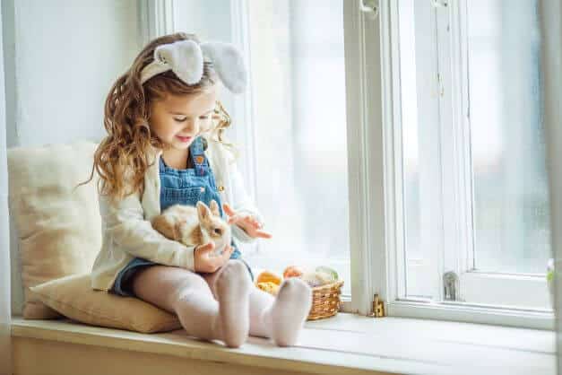 adorable child holding a rabbit