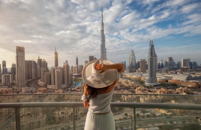 Woman looks over dubai cityscape