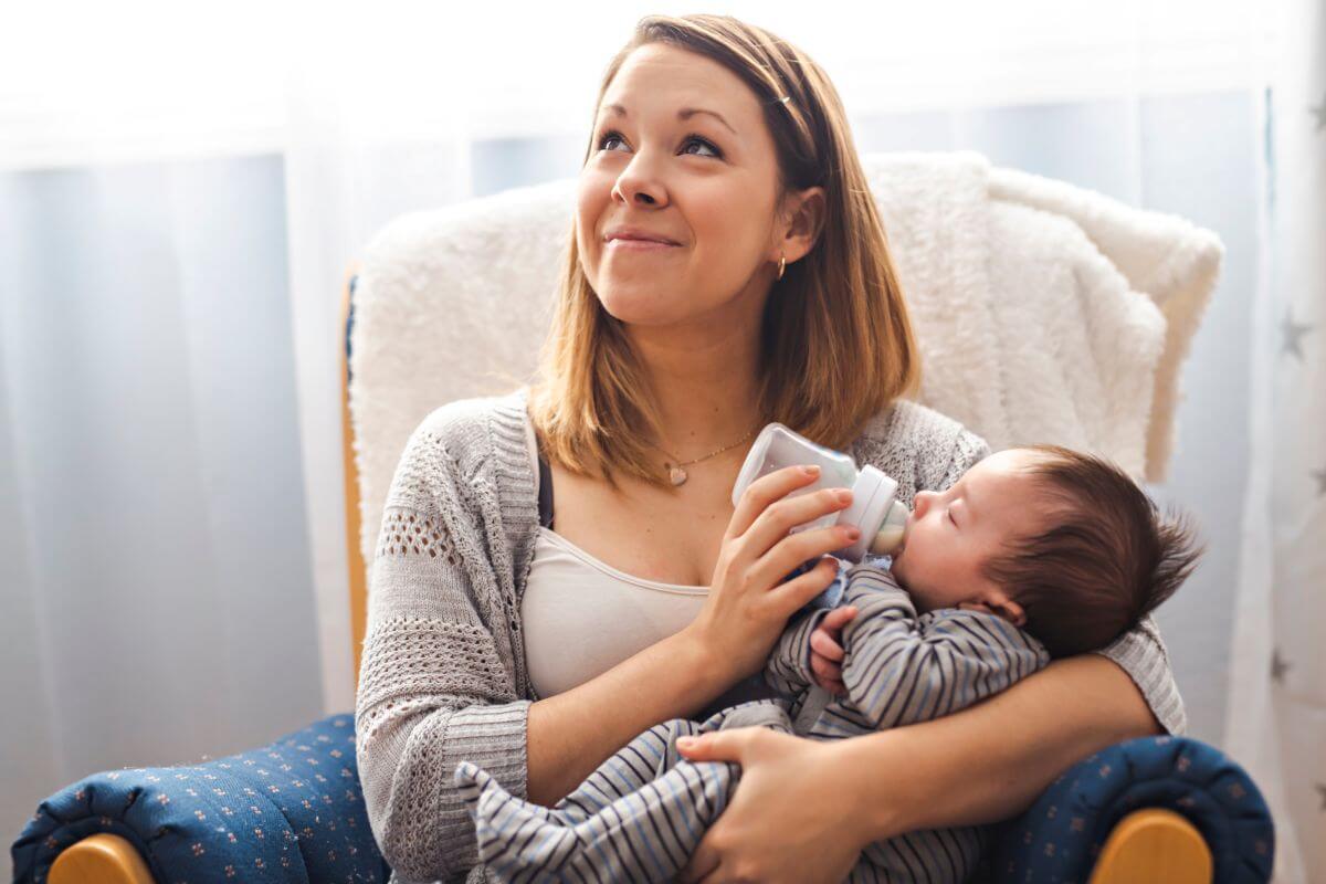 mother feeding baby with bottle