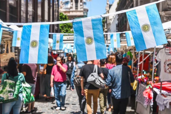 Famous markets in San Telmo, oldest part of Buenos Aires decorated with Argentinian flags Buenos Aires / Argentina - 11/10/2019: Famous markets in San Telmo, oldest part of Buenos Aires decorated with Argentinian flags