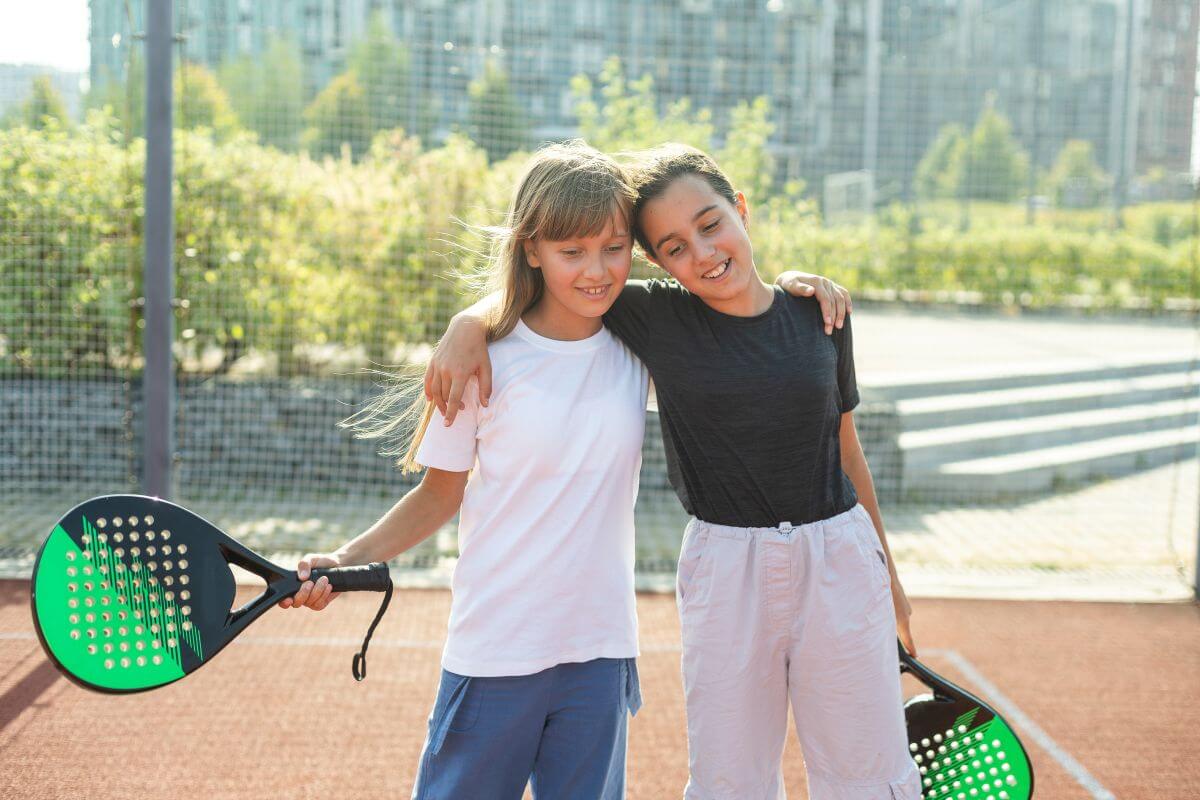 two young girls playing padel