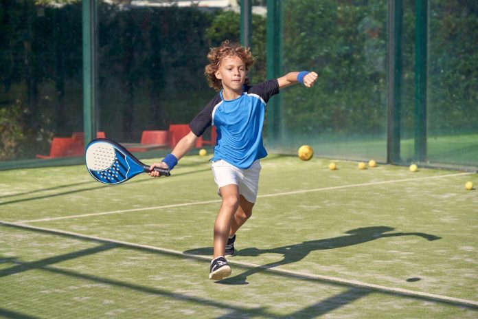 young boy playing padel